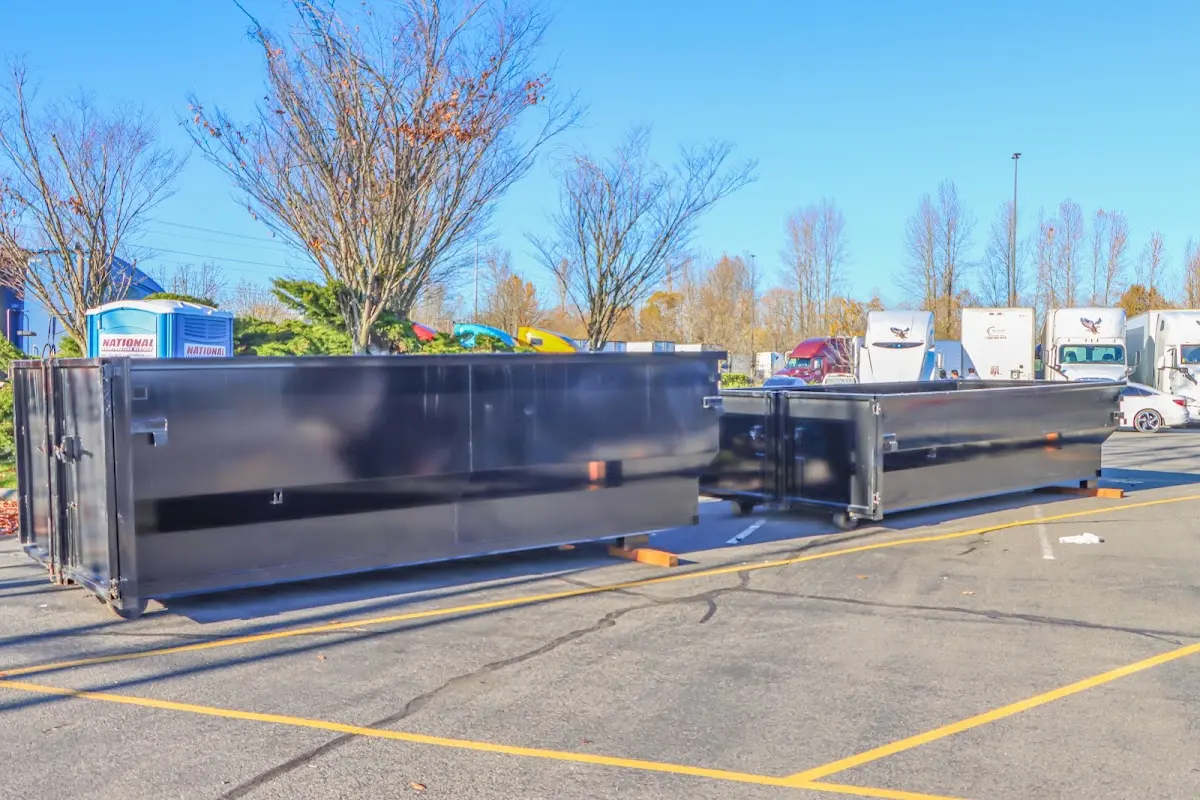 Professional dumpster rental service with roll-off container on residential driveway in Niceville